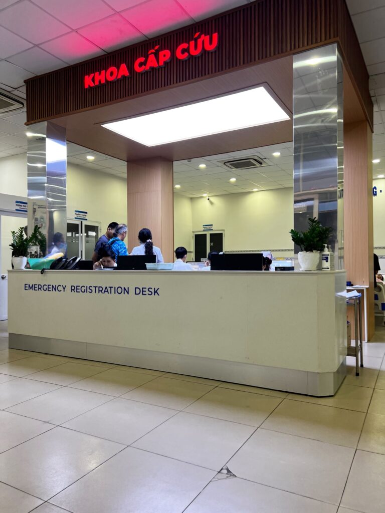 HCMC Public Hospital District 1 interior reception desk in English and Vietnamese